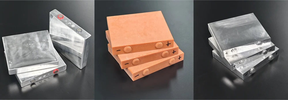 Prismatic cell dummy models in three variants, left to right: aluminium with a filling port, Bakelite, and aluminium without a filling port